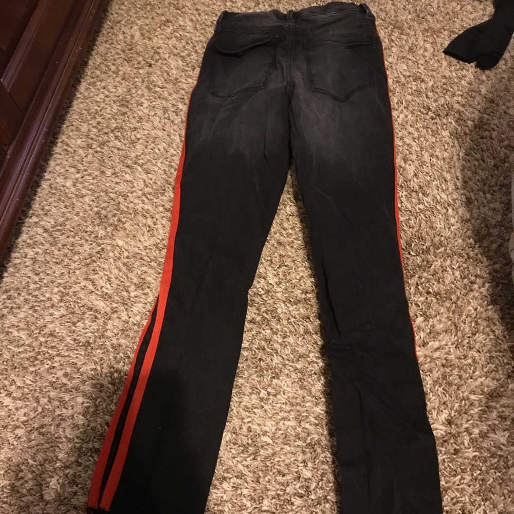 Black pants with red strips.
